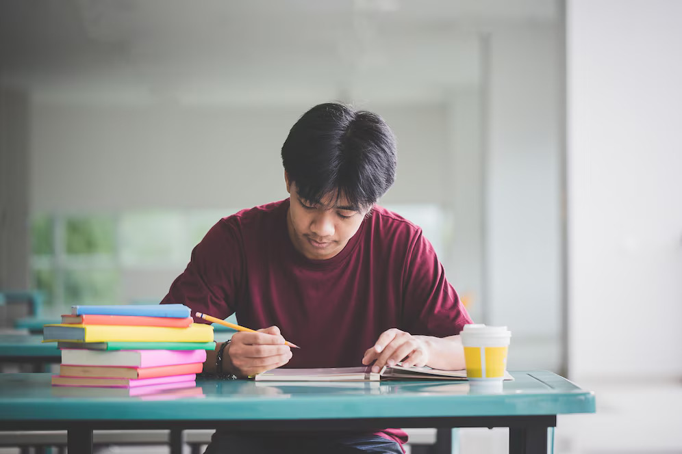man-writing-table-cafeteria_1048944-29437828